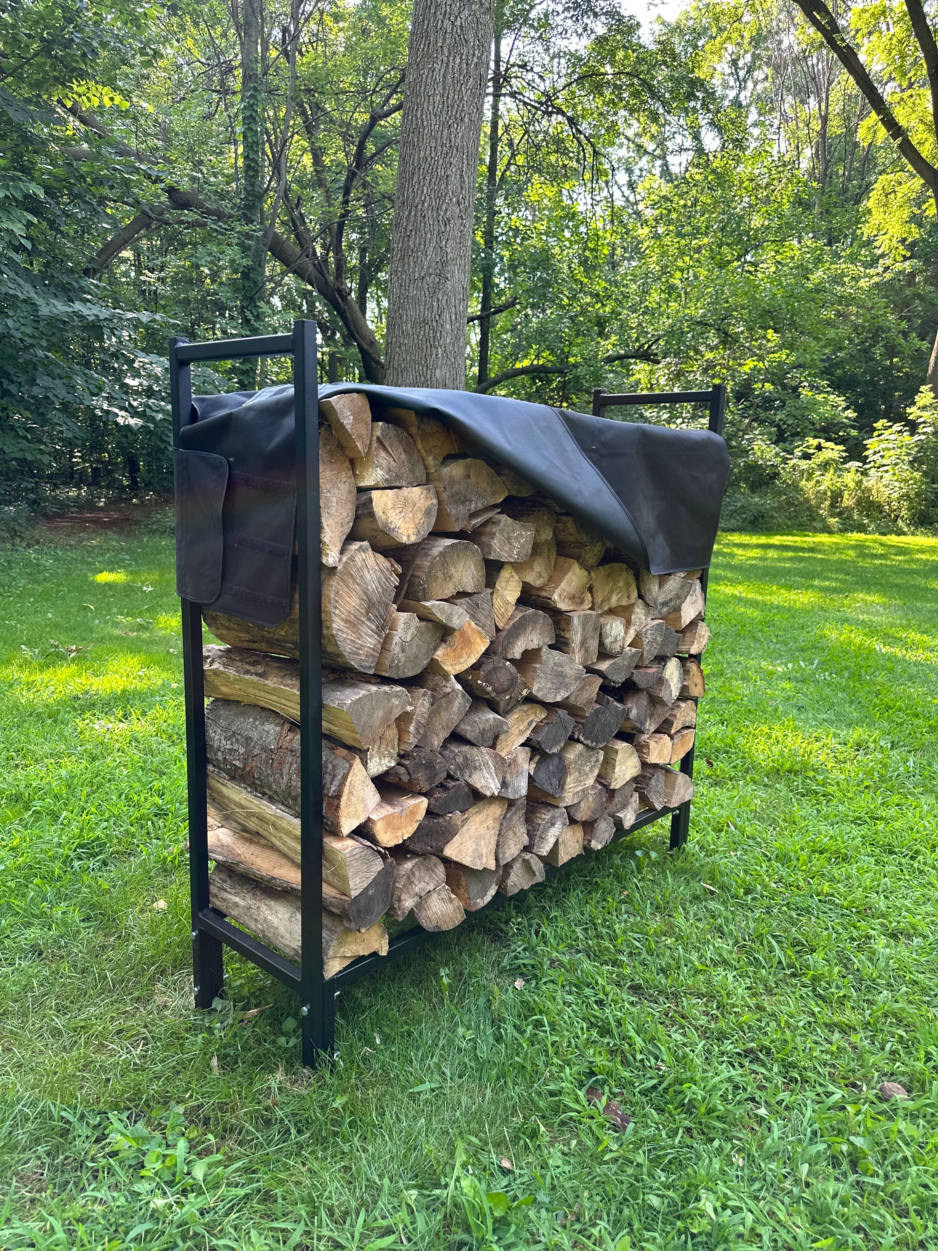 Firewood stacked on a usa metal rack outdoors with trees and grass in the background durable cover